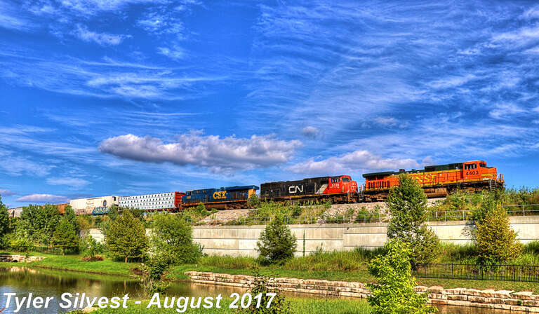Burlington Northern Santa Fe 4403(C44-9W), Canadian National 5739(SD75I) and CSX Railroad 5297(ES44DC) Lead a Southbound Manifest that is tied down near the Ridgeview Road Overpass South of Santa Fe Street in Olathe, Kansas along the BNSF Fort Scott