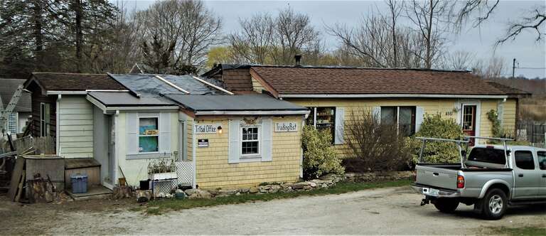 The house at 4561 Main Road in Tiverton, Rhode Island has signs on it which read &quot;Tribal Office&quot; and &quot;Trading Post&quot;.  On the flag pole outside are flags reading &quot;The Royal Council of Seven Royal House / Pokanoket Tribe / Pokanoket Nation&quot; and