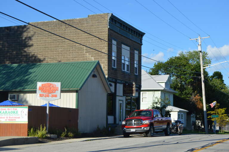 Commercial building and house on the northern side of Main Street (State Route 347) at the Center Street intersection in Broadway, Ohio, United States.