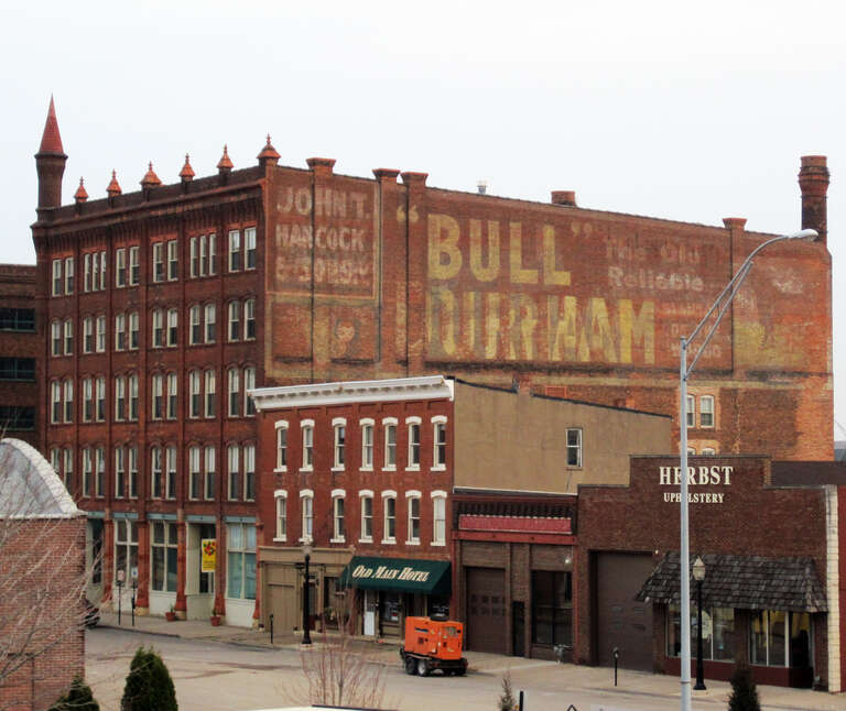 Ghost sign, Dubuque. Part of a series.  The sign is on the side of the Bishop's Block, located at 90 W. Main Street, an National Register of Historic Places listed structure.