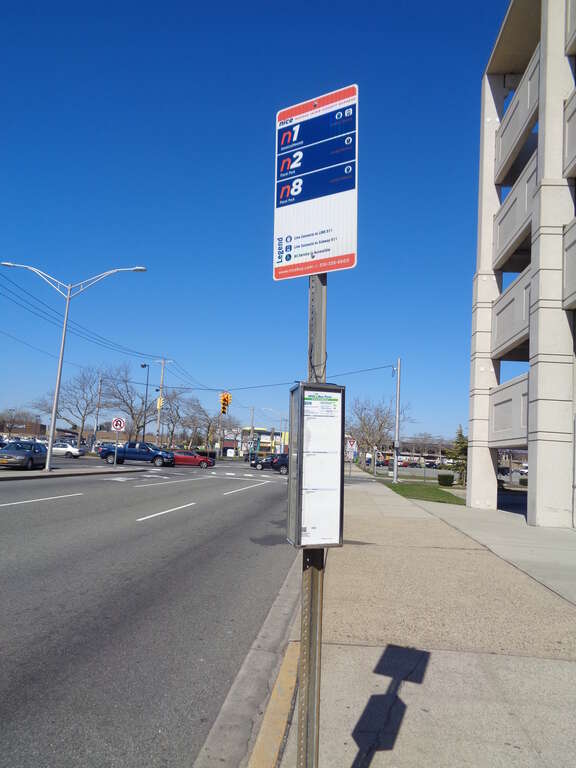 A bus stop sign at Green Acres Mall in Valley Stream, Nassau County. This is a stop for the n1, n2, and n8 routes of the Nassau Inter-County Express of Nassau County, as well as the outbound (Jamaica, Queens-bound) stop for the Q5 and Q85 of the MTA.
