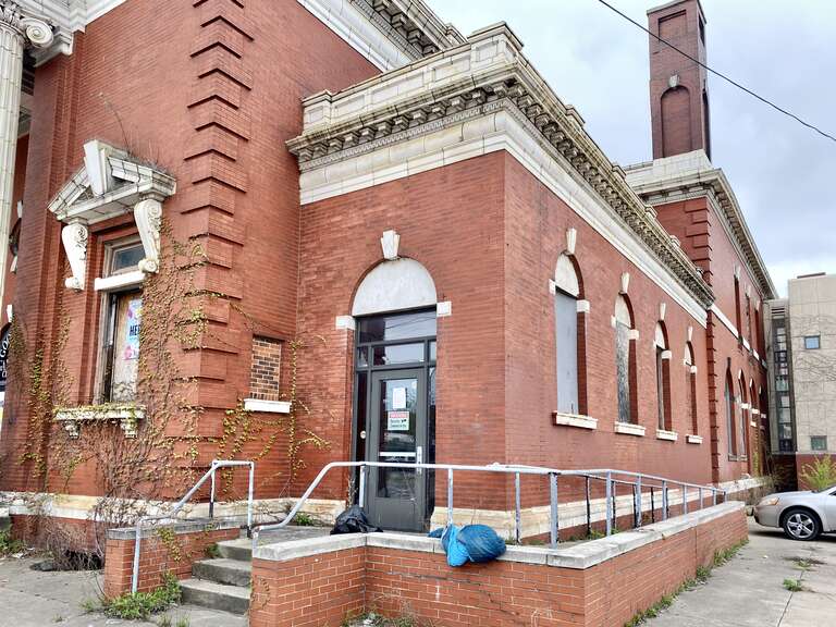 Built in 1904, this Classical Revival-style building was designed by William R. Watterson and Charles S. Schneider to house the Lake Shore Bank and the St. Clair Branch Library.  The building features a wedge-shaped footprint, with the larger