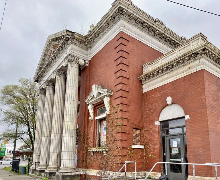 Built in 1904, this Classical Revival-style building was designed by William R. Watterson and Charles S. Schneider to house the Lake Shore Bank and the St. Clair Branch Library.  The building features a wedge-shaped footprint, with the larger