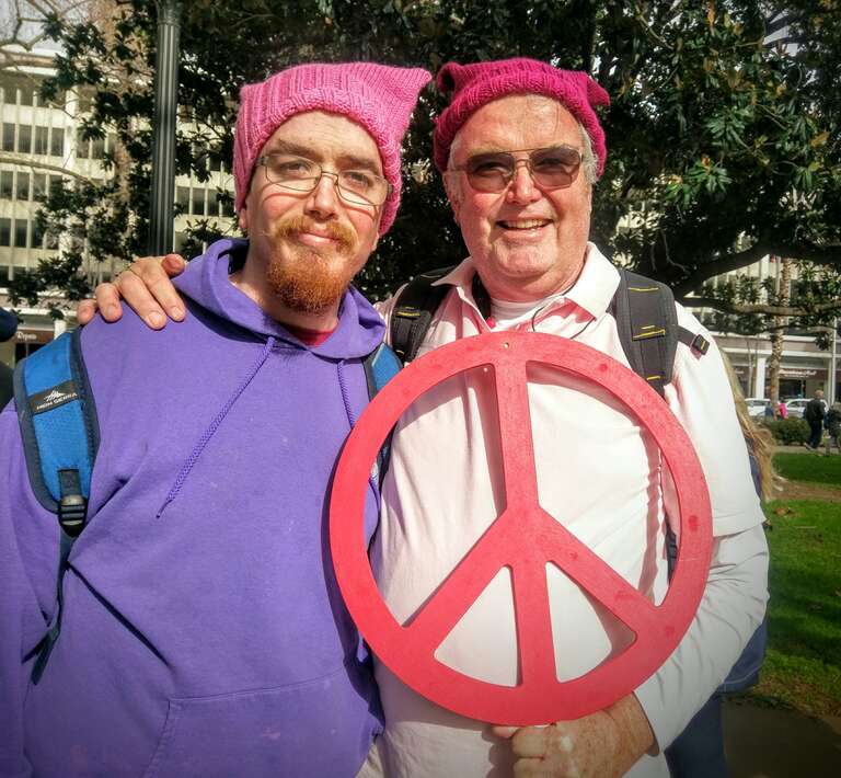 Two men wearing pussyhats at the Sacramento Women's March.