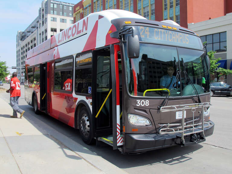 Photo of StarTran bus #308, route #24 (Holdrege) running CNG in downtown Lincoln, Nebraska.  Photo is taken at the bus stop on the north side of &quot;Q&quot; Street in-between N. 12th &amp;amp; N. 13th Streets, looking east-southeast.