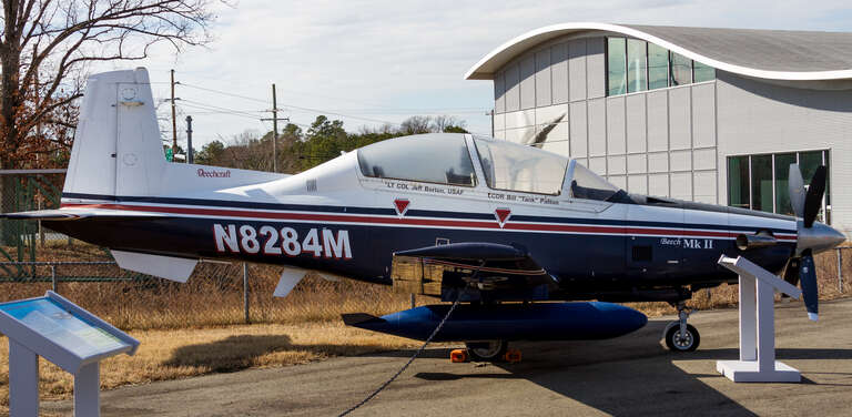 A Raytheon T-6A Texan II on display at the Patuxent River Naval Air Museum in Lexington Park, Maryland. This T-6 had a civil registration N8284M and was a prototype aircraft used for development and testing the Raytheon, the FAA, and the Navy.  It