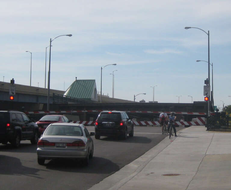 Cars and cyclists waiting during a lift of the Clybourn Street Lift Bridge, in Milwaukee, Wisconsin