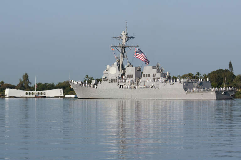 The U.S. Navy destroyer USS Chafee sailing past the USS Arizona Memorial as part of ceremonies commemorating the 69th anniversary of the Pearl Harbor attack.
