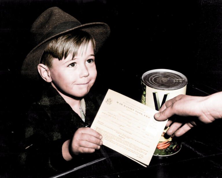An American school boy using a War Ration Book to exchange a tin of V8 vegetable beverage. Rationing in the United started with the British government encouraging the US to do so. What in a first moment affected to tire and car manufacturers, soon