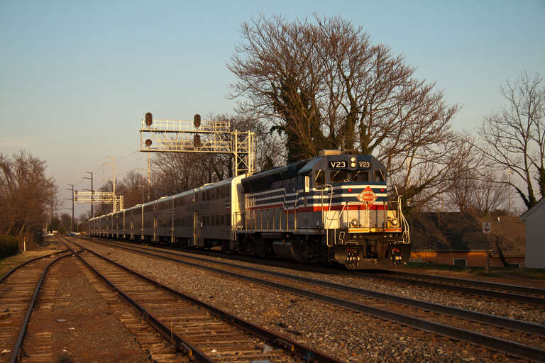 An evening VRE commuter train is approaching the Manassas, VA station.  Led by a GP40, the train left Union Station in Washington, DC about a hour before.