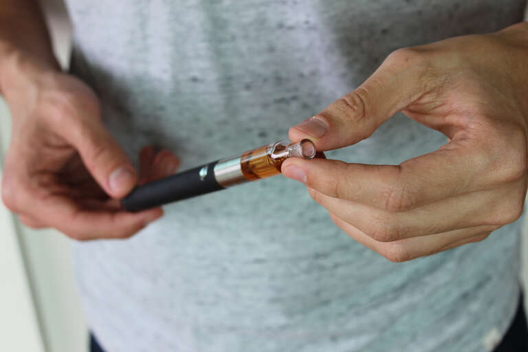 500px provided description: Holding a vaporizer pen. [#smoking ,#cigarette ,#hand ,#tobacco ,#nicotine ,#vaper ,#e-cigarette ,#vaporizer ,#vaping]
