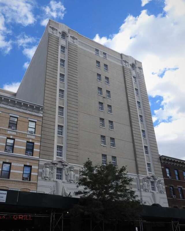Looking southeast at building on Amsterdam Avenue on a mostly cloudy day