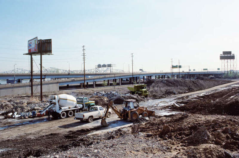 Looking NE from near present-day (2016) intersection of Brook and Witherspoons Streets.
This area is now (2016) part of Waterfront Park.
The on-ramp to eastbound I-64 seen here has been rebuilt farther west.
.
Louisville, Kentucky.
April 1988.
.
file
