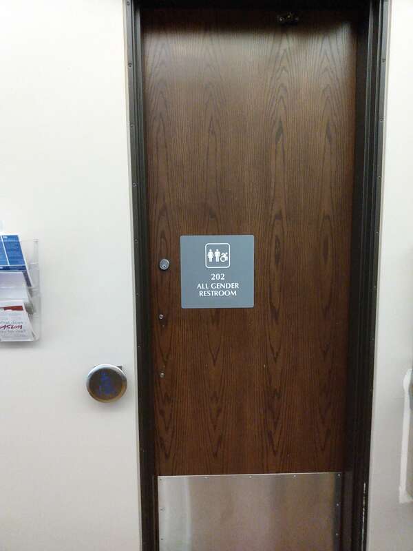 A sign on a door for an All Gender Restroom in the University Center at the University of Montana.