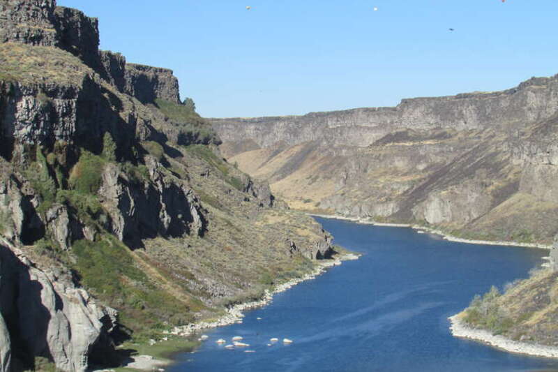 Snake River Canyon below Shoshone Falls is 460 ft deep and just over a mile and a quarter to the bend.