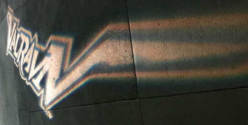 Logo of Valravn (roller coaster) shown in light on sidewalk at Cedar Point.