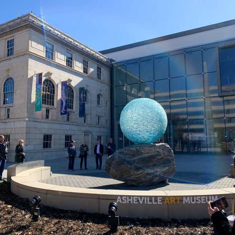 &quot;Reflections on Unity&quot; is a chiseled glass orb sculpture by the artist Henry Richardson. It is in the public plaza in front of the Asheville Art Museum in Asheville, NC.