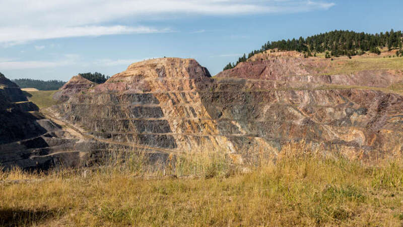 500px provided description: Abandoned open pit mine of the former Homestake Gold Mine (now the Sanford Lab Homestake Visitor Center) in Lead, South Dakota.

Hometake mine stopped production of gold in 2001 and is now the Sanford Underground