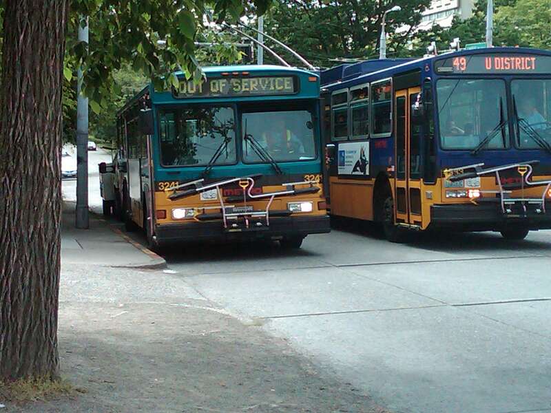 The Gillig wouldn't start, so the shop truck had to push it around the corner so it wasn't blocking.