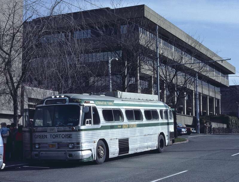 A Green Tortoise bus loading in Seattle in 1984, on NE Campus Parkway, in the University District.  Bus 401 is a General Motors PD-4104, a type of bus that was in production from 1953 to 1960.  Green Tortoise (founded in 1973) acquired this one