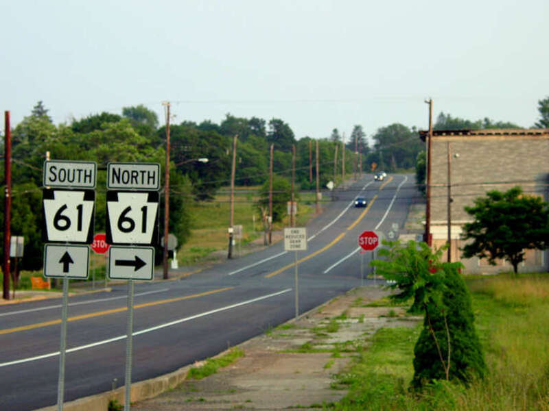 PA Route 61 in Centralia at the terminus of PA Route 42. The bend in the road in the background is where the highway was diverted onto a much smaller local road due to the heavy road damage from the underground fire.
Picture: June 2002 (Building to