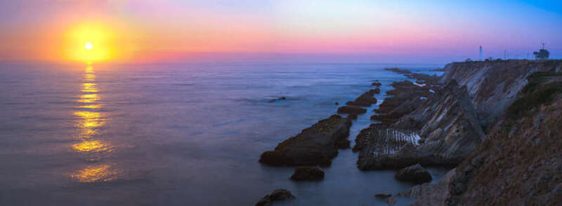 500px provided description: Point Arena Lighthouse, operating since 1870, rebuilt after the 1906 earthquake. Significant rift in the rock face is caused by the San Andreas fault. [#sunset ,#coast ,#lighthouse ,#twilight ,#rocks ,#california