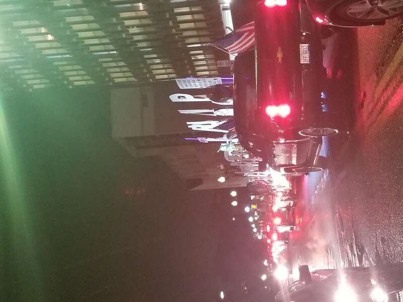 A lone protester (shouting and rants about conspiracy theories and Benghazi) and holds up traffic by parking a flattop trailer with a pro-trump anti-Clinton protest display outside of the theater's parking garage
