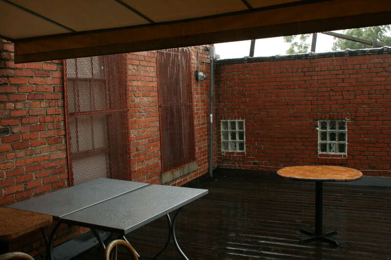 View of the outdoor patio at Cosmic Cantina, a Mexican-style restaurant, in the rain in Durham, North Carolina.