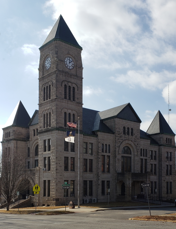 A large limestone building with a clock tower built in 1896-97, used for official county business, located at 423 North 5th Street / Parallel Street, Atchison, Kansas.