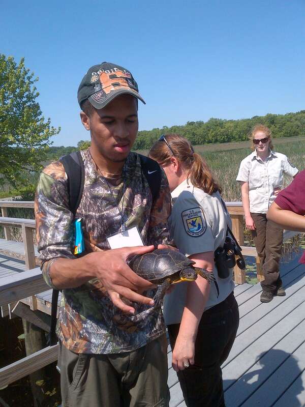 Ryan holding the Blanding's Turtle. 
Credit: Juancarlos Giese/USFWS