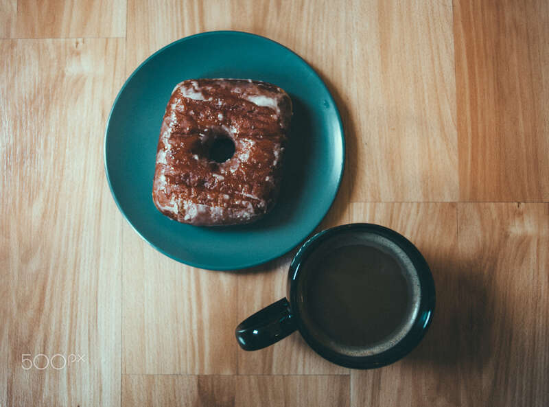 500px provided description: A sweet breakfast ... ready to eat! [#square ,#breakfast ,#nyc ,#ikea ,#table ,#circles ,#wood panel ,#coffee mug ,#square doughnut ,#doughnut plant]