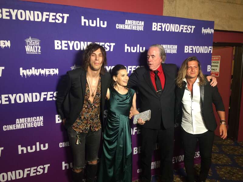 Axiom, Manuel, Terri Newman, and Curtis Webster posing at the Mister America film premiere.
