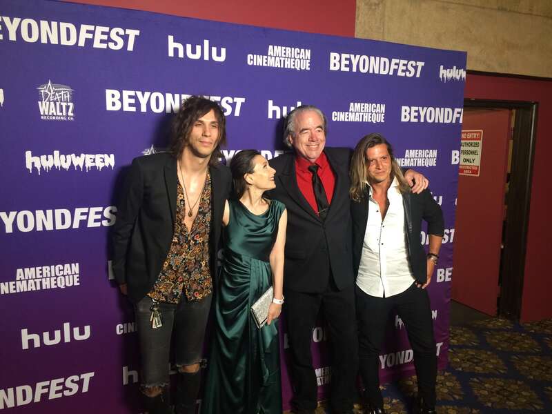 Axiom, Manuel, Terri Newman, and Curtis Webster posing at the Mister America film premiere.