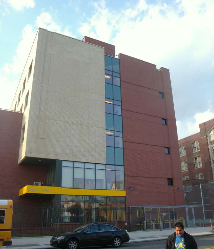 Looking west across 17th Avenue from Rutherford Place at PS 163 The Bath Beach School on a mostly sunny afternoon. EXIF location is mistaken due to photographer's error.