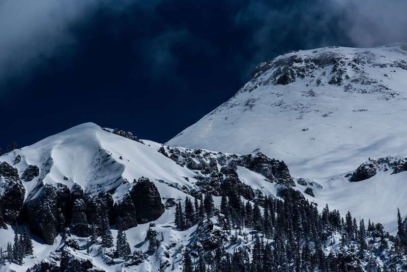500px provided description: Smooth mountains in Colorado with the clouds moving in around them [#trees ,#sky ,#forest ,#beauty ,#mountains ,#winter ,#spring ,#travel ,#blue ,#sun ,#light ,#clouds ,#tree ,#beautiful ,#white ,#snow ,#black ,#mountain]