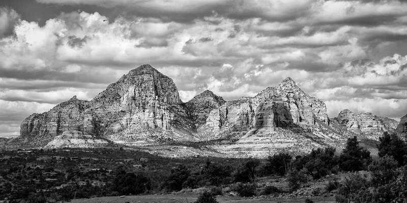 500px provided description: A shot of Thunder Mountain in Sedona, Arizona. Clouds shaded the foreground while the sun overhead lit up Thunder Mountain across the valley. I was able to use a small aperture to capture the depth of the scene and keep