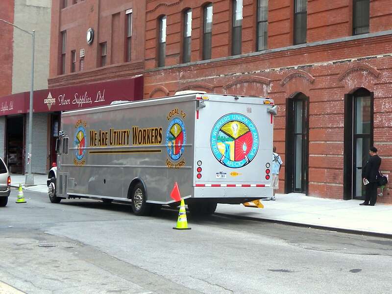 Looking southeast along E124th Street at truck of UWUA on a mostly cloudy midday.