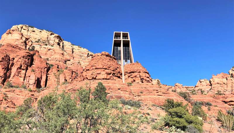 The Chapel of the Holy Cross is a Roman Catholic chapel built from 1954 to 1956 into the red rock buttes of Sedona, Arizona, within the Coconino National Forest. It was inspired and commissioned by local rancher and sculptor Marguerite Brunswig