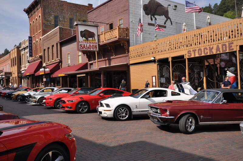 Deadwood Historic District, encompassing virtually all of Deadwood, South Dakota.  Main Street, with a Ford Mustang car show.