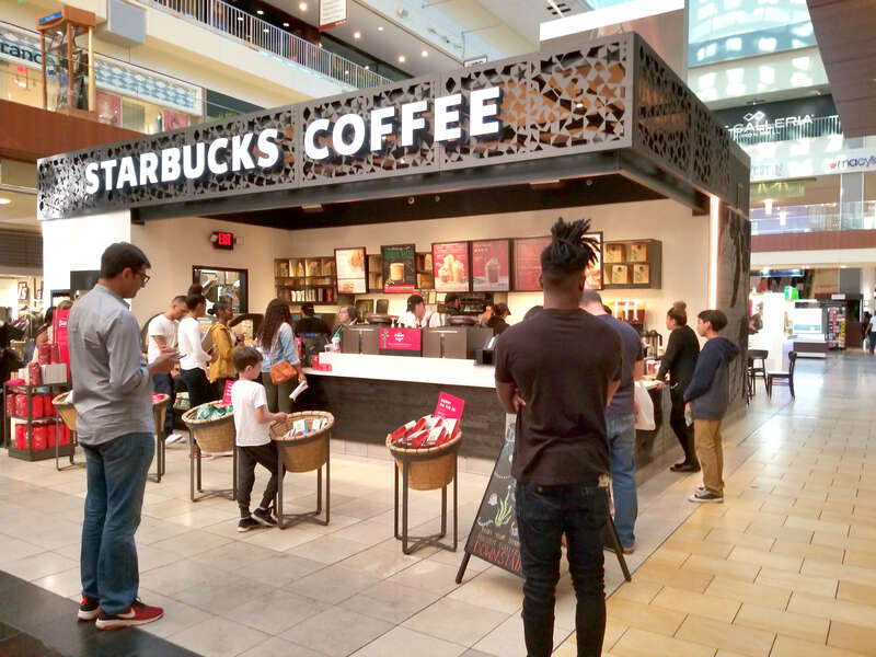 People wait to order as others wait for their coffee at the Galleria Mall in Houston, Texas