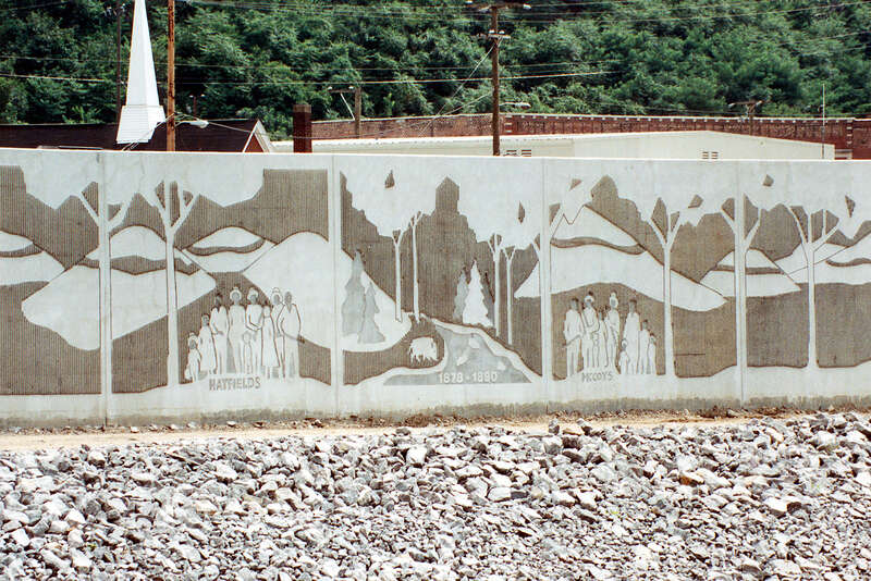 Close-up of a section of the floodwall along the Tug Fork River at Matewan, West Virginia, USA. The U.S. Army Corps of Engineers constructed levees and floodwalls along the river to protect the town. The wall depicts the families involved in the