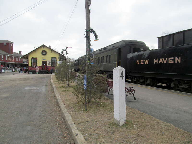 Excursion train and an old milepost at the Valley Railroad's Essex station in December 2016