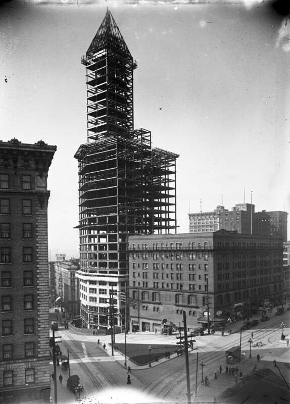 Seattle's Smith Tower under construction, 1913. Other prominent buildings in the picture are the Frye Hotel (now Frye Apartments) at left, the triangular Seattle Hotel (demolished in the 1960s) just left of the Smith Tower and the Morrison Hotel just