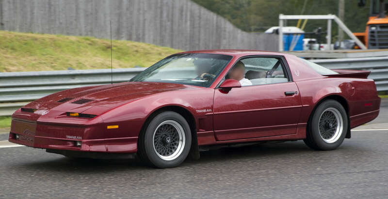 1987 Pontiac Firebird Trans Am in Flame Red Metallic (paint code 74), taking part in the Meeting of the Marques at the 2021 Lime Rock Historic Festival. 5.7-liter V8 engine.