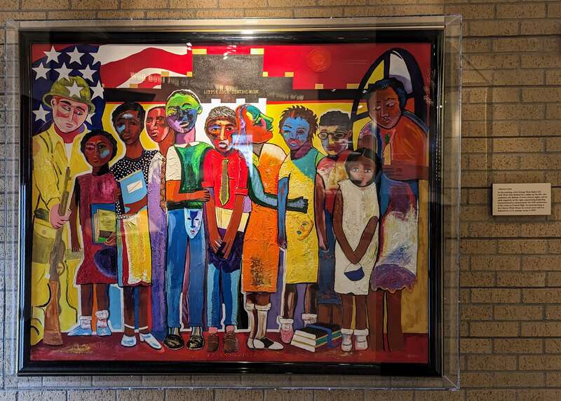 This 1997 painting by George Hunt hangs in the visitor center of the Central High School visitor center in Little Rock, AR. It depicts the Little Rock Nine, the first black students to desegregate Central High School, along with a military figure on