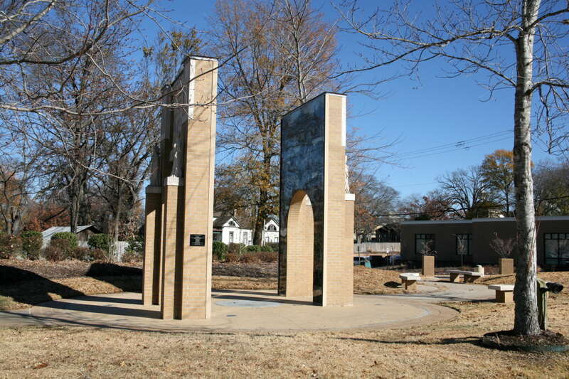 Two monumental arches mimic the architecture of the school building -- the classical arches and four symbolic human figures