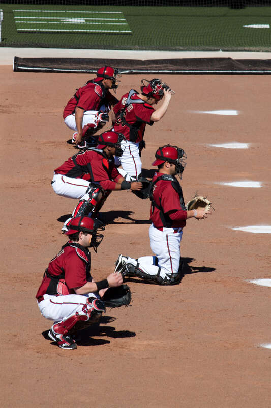 Arizona Diamondbacks catchers, including Miguel Montero, Konrad Schmidt and P. J. Pilittere, catch bullpen sessions during spring training in February 2011.
