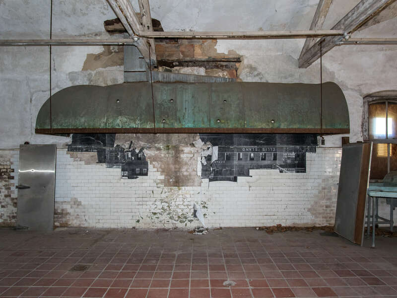 The kitchen in the Ellis Island Immigrant Hospital, closed since 1930. The photograph is one from the early 20th century, when the hospital was operational. In 2014 the French artist JR put up large reproductions of such photographs around the