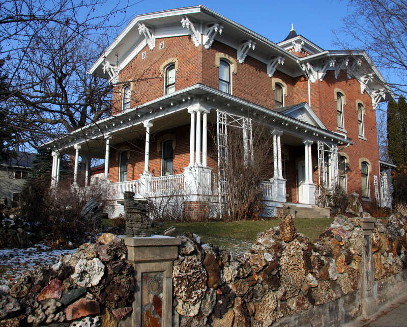 The Porter House Museum at 401 West Broadway, Decorah, Iowa, built in 1867 and listed on the National Register of Historic Places as the Ellsworth-Porter House, seen with its ornate stone wall from the sidewalk on River Street