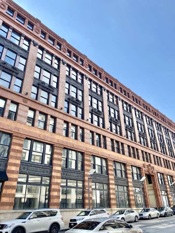 Built in 1906, this Beaux Arts-style building was designed by Eames and Young for the Ely and Walker Dry Goods Company.  The building features a red brick exterior with orange and black terra cotta trim, one-over-one double-hung windows, rusticated